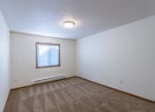 Thumbnail 8 of 49 - a bedroom with carpet and a window. Fargo, ND Lake Crest Apartments