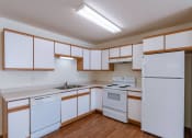 Thumbnail 7 of 49 - a kitchen with white appliances and white cabinets. Fargo, ND Lake Crest Apartments