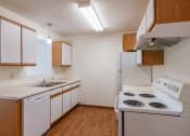 Thumbnail 26 of 49 - a kitchen with stove and sink. Fargo, ND Lake Crest Apartments