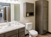 Thumbnail 31 of 49 - Fargo, ND Lake Crest Apartments. A bathroom with a toilet sink and mirror