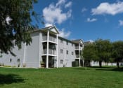 Thumbnail 48 of 49 - Fargo, ND Lake Crest Apartments. A large apartment complex with a grassy area in front of it