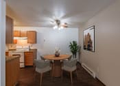 Thumbnail 2 of 30 - a dining area with a table and chairs and a ceiling fan. Fargo, ND Long Island Apartments