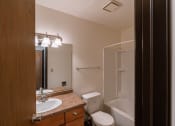 Thumbnail 15 of 30 - A bathroom with a sink toilet and shower. Fargo, ND Long Island Apartments.