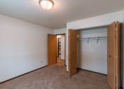 Thumbnail 13 of 30 - An empty bedroom with a closet and a mirrored closet door. Fargo, ND Long Island Apartments.