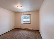 Thumbnail 12 of 30 - a bedroom with a window and carpeted floors. Fargo, ND Long Island Apartments.