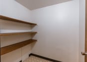 Thumbnail 17 of 30 - A small room with shelves and a door. Fargo, ND Long Island Apartments.