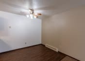 Thumbnail 11 of 30 - A dining room with a ceiling fan and wood floors. Fargo, ND Long Island Apartments.