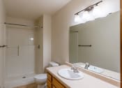 Thumbnail 11 of 13 - a bathroom with a sink and a toilet and a shower. Moorhead, MN Mallard Creek Apartments