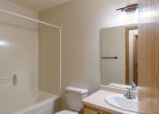 Thumbnail 12 of 13 - a bathroom with a sink and a toilet and a shower. Moorhead, MN Mallard Creek Apartments