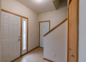 Thumbnail 13 of 13 - an entry door with a closet and door to the garage. Moorhead, MN Mallard Creek Apartments