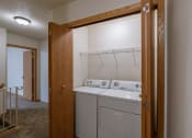 Thumbnail 10 of 13 - a laundry closet on the second floor of a townhome with a washer and dryer. Moorhead, MN Mallard Creek Apartments