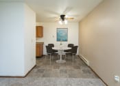 Thumbnail 4 of 20 - a dining area with a table and chairs. Fargo, ND Maplewood Bend Apartments