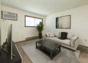 Thumbnail 1 of 20 - a living room with a couch and a coffee tableFargo, ND Maplewood Bend Apartments