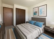Thumbnail 5 of 20 - a bedroom with a bed and two doors. Fargo, ND Maplewood Bend Apartments