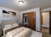 Thumbnail 5 of 20 - a bedroom with a bed and a closet with a closet door. Fargo, ND Martha Alice Apartments