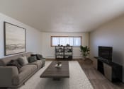 Thumbnail 3 of 20 - a living room with a couch and a coffee table. Fargo, ND Martha Alice Apartments