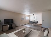 Thumbnail 4 of 20 - a living room with a couch and a table and a tv. Fargo, ND Martha Alice Apartments