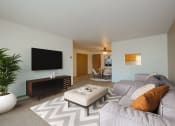 Thumbnail 1 of 17 - a living room with a large couch and a tv. Fargo, ND Maybrook Apartments
