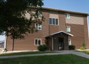 Thumbnail 17 of 17 - a brick apartment building with a sidewalk in front of it. Fargo, ND Maybrook Apartments