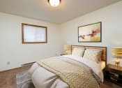 Thumbnail 8 of 26 - Fargo, ND Monticello. A bedroom with a bed, two night stands, and a small window .