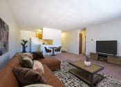 Thumbnail 5 of 16 - a living room with a couch and a television. Fargo, ND North Manor Apartments