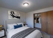 Thumbnail 2 of 16 - a bedroom with a bed and a closet. Fargo, ND North Manor Apartments