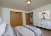 Thumbnail 2 of 11 - Bedroom with a bed and a closet and a door to a bathroom at Oak Court Apartments, Fargo, ND, 58103