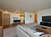 Thumbnail 3 of 11 - Living room of an apartment with a couch and a television at Oak Court Apartments, Fargo