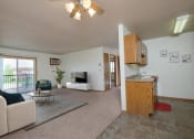 Thumbnail 1 of 11 - Living room with a couch and a table and a television, Oak Court Apartments, 58103