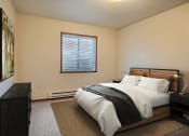 Thumbnail 8 of 31 - Fargo, ND Oxford Apartments. a bedroom with a bed and a window