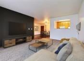 Thumbnail 5 of 31 - Fargo, ND Oxford Apartments. a living room with a couch and a coffee table