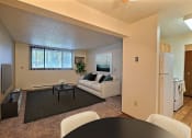 Thumbnail 4 of 28 - a living room with a couch and a table. Fargo, ND Pacific Park 2 Apartments.