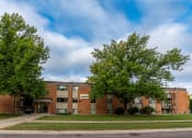 Thumbnail 22 of 22 - Fargo, ND Pacific Park Apartments. An apartment building with trees in front of it
