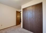 Thumbnail 19 of 28 - a bedroom with two closets and a door to a hallway. Fargo, Pacific Park II Apartments