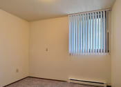Thumbnail 17 of 28 - an empty room with a window and a radiator. Fargo, Pacific Park II Apartments