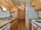 Thumbnail 15 of 28 - a kitchen with a sink and a refrigerator. Fargo, Pacific Park II Apartments