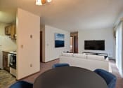 Thumbnail 2 of 18 - a living room with a couch and a table. Fargo, ND Pacific South Apartments