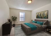Thumbnail 4 of 25 - Bedroom with a bed and a dresser and a window at Park Place Apartments in Fargo, ND, 58103