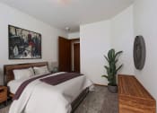 Thumbnail 3 of 25 - Bedroom with a bed and a potted plant at Park Place Apartments in Fargo, ND