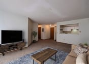 Thumbnail 2 of 25 - Living room with a couch and a coffee table and a tv at Park Place Apartments in ND