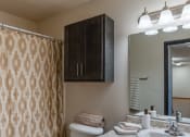 Thumbnail 9 of 16 - Fargo, ND Parkside Apartments. A bathroom with a toilet, sink, and bathtub