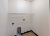 Thumbnail 11 of 16 - Fargo, ND Parkside Apartments.  A closet with laundry attachments.
