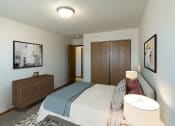 Thumbnail 4 of 16 - Fargo, ND Parkside Apartments. A bedroom with a bed and a dresser
