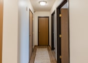 Thumbnail 10 of 16 - Fargo, ND Parkside Apartments. A corridor with two doors and a carpeted floor