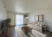 Thumbnail 1 of 16 - Fargo, ND Parkside Apartments. A living room with a couch, coffee table, tv, and a glass sliding door.