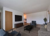 Thumbnail 1 of 23 - Living room filled with furniture and a flat screen tv at Parkwest Gardens West ND 58078