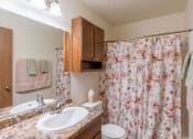 Thumbnail 8 of 10 - a bathroom with a shower curtain and a sink and a toilet. Fargo, ND Parkwood