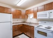 Thumbnail 5 of 10 - a kitchen with white appliances and wooden cabinets. Fargo, ND Parkwood