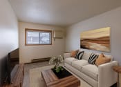 Thumbnail 2 of 10 - a living room with a couch and a coffee table. Fargo, ND Parkwood East and West Apartments