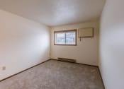 Thumbnail 4 of 10 - the living room of an apartment with carpet and a window. Fargo, ND Parkwood